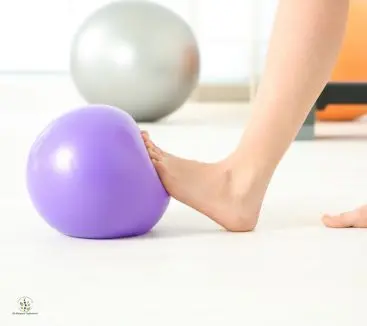Foot performing balance exercise on stability ball during therapeutic exercise session at Advance Physiotherapy Clinic, Chhatrapati Sambhajinagar