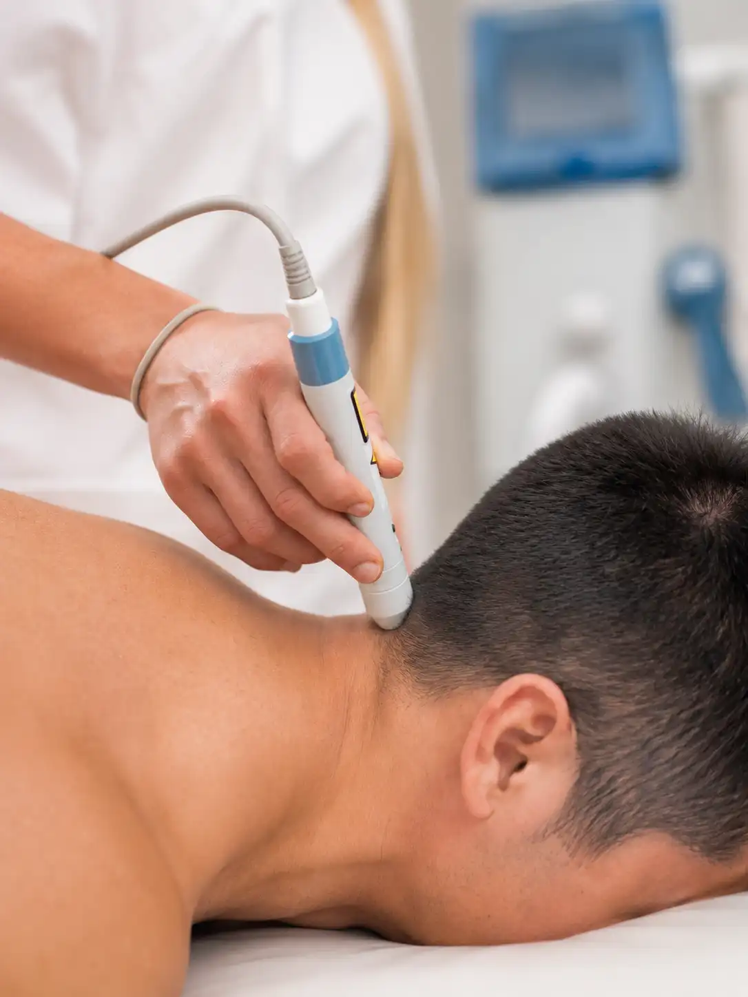Laser therapy treatment for neck pain performed by a physiotherapist using a handheld laser device on a patient in a physiotherapy clinic.